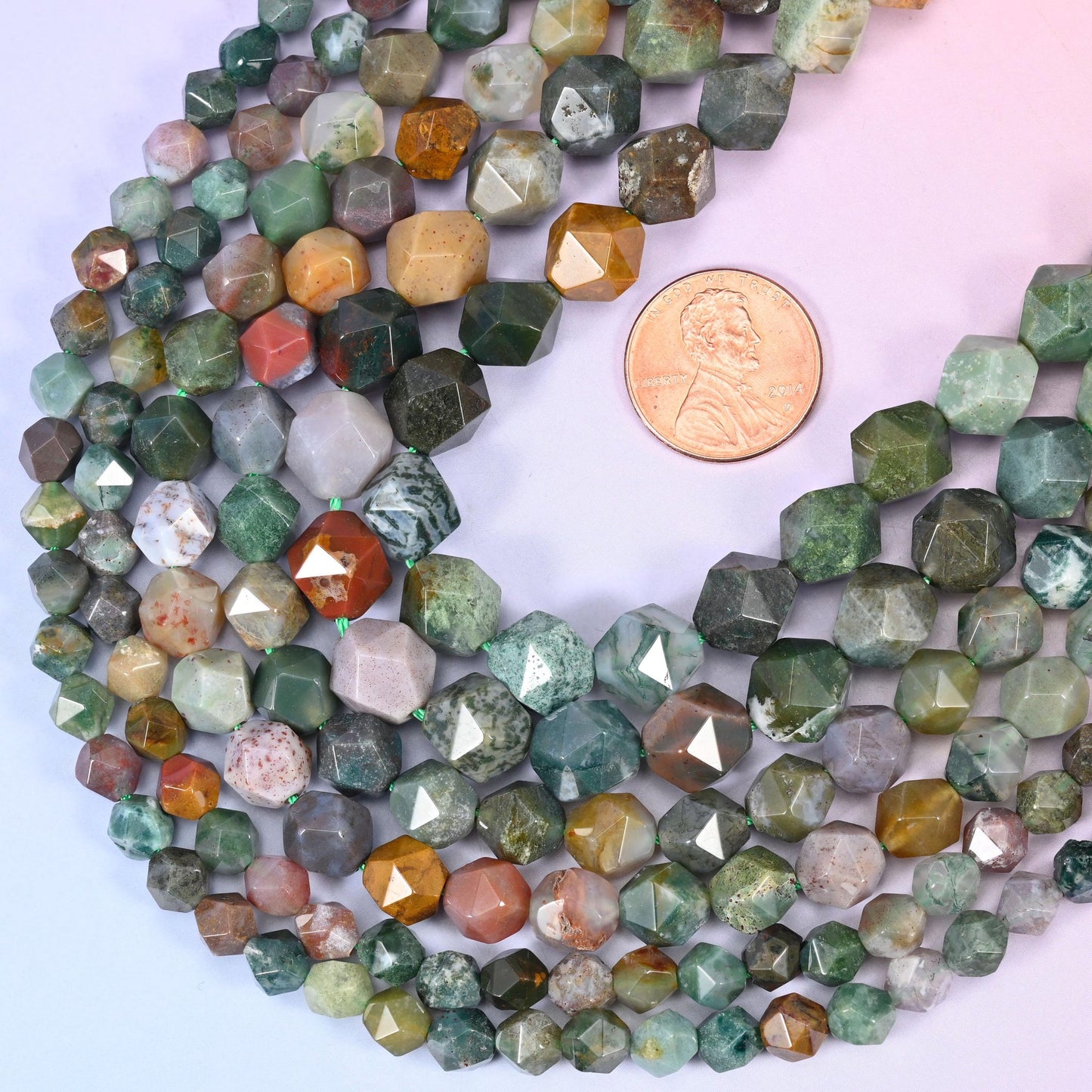 Indian Agate star cut beads with a US penny alongside for size reference, available in 6mm, 8mm and 10mm