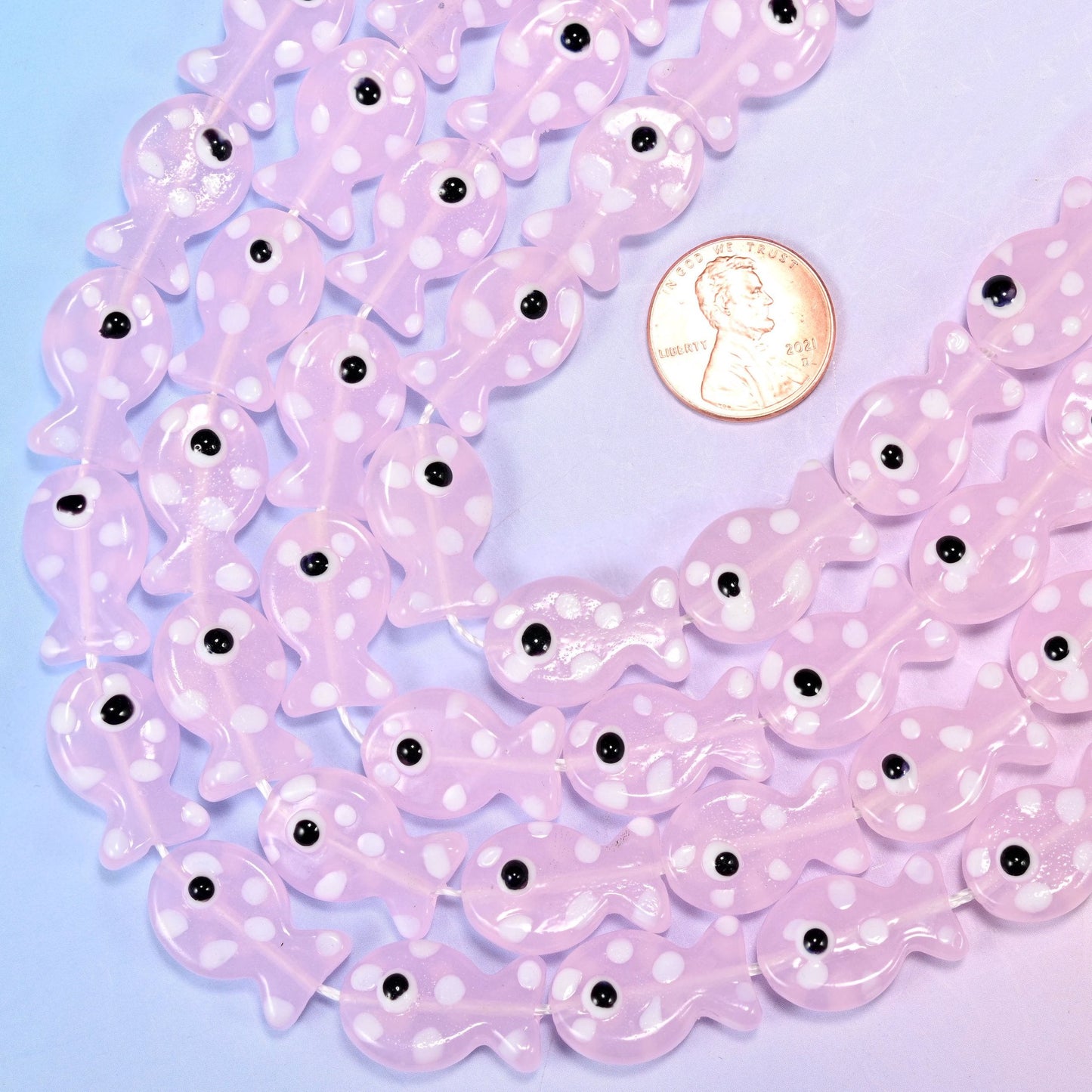 Fish-shaped pink glass beads with white dot pattern