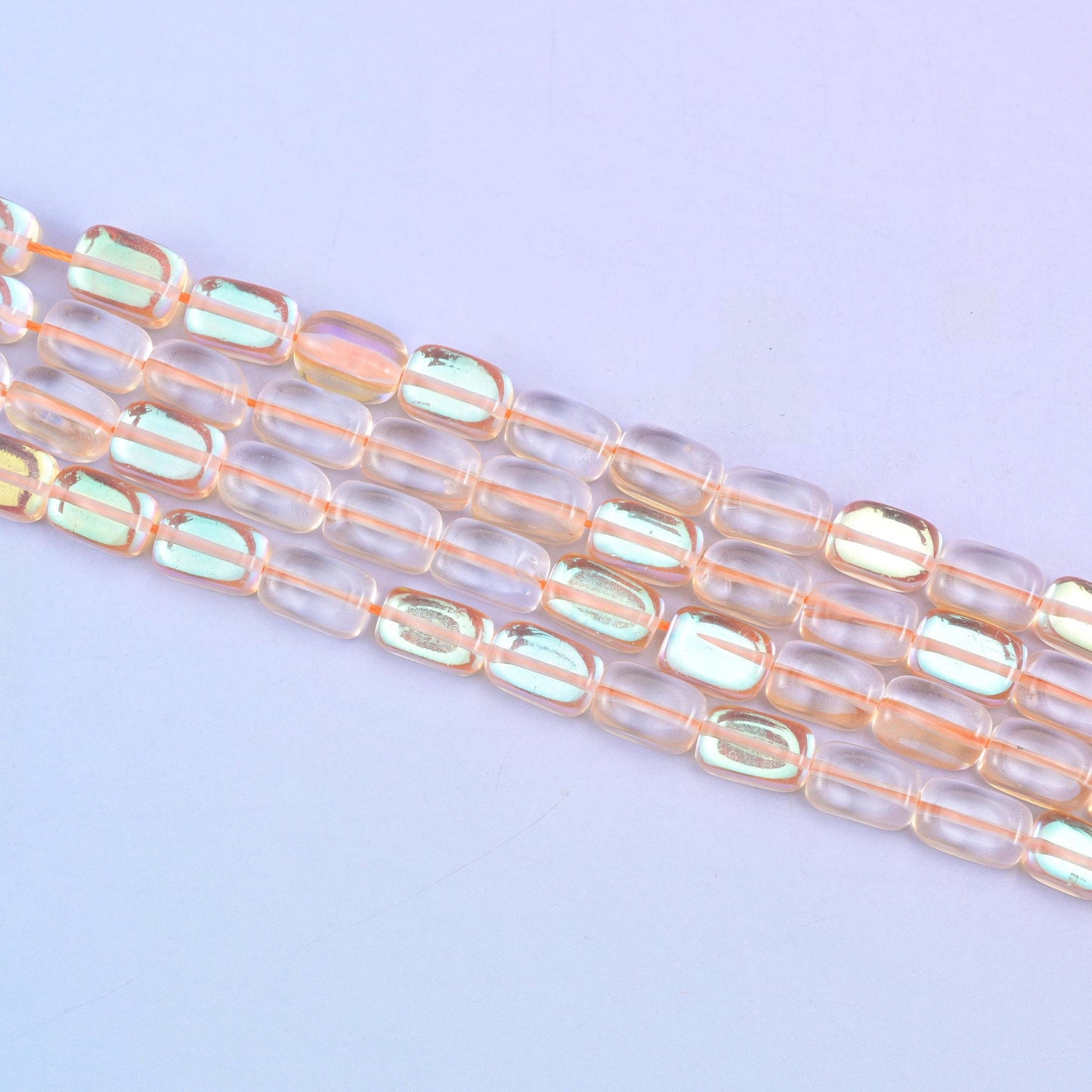 Orange Mystic Aura glass beads in a warm amber-orange shine with a subtle iridescent glow