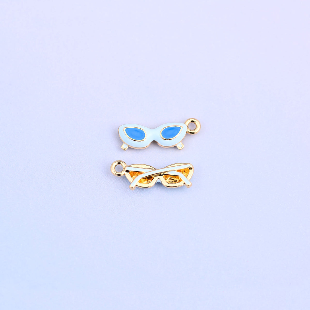 White cat eye sunglasses charm with blue lenses, front and back.