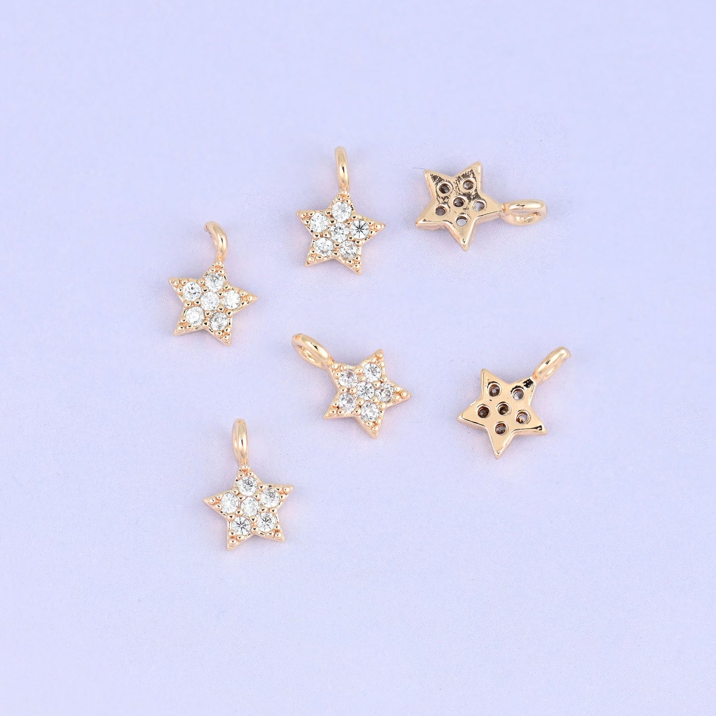 Small gold charms, seven star charms with two turned to show the plain back