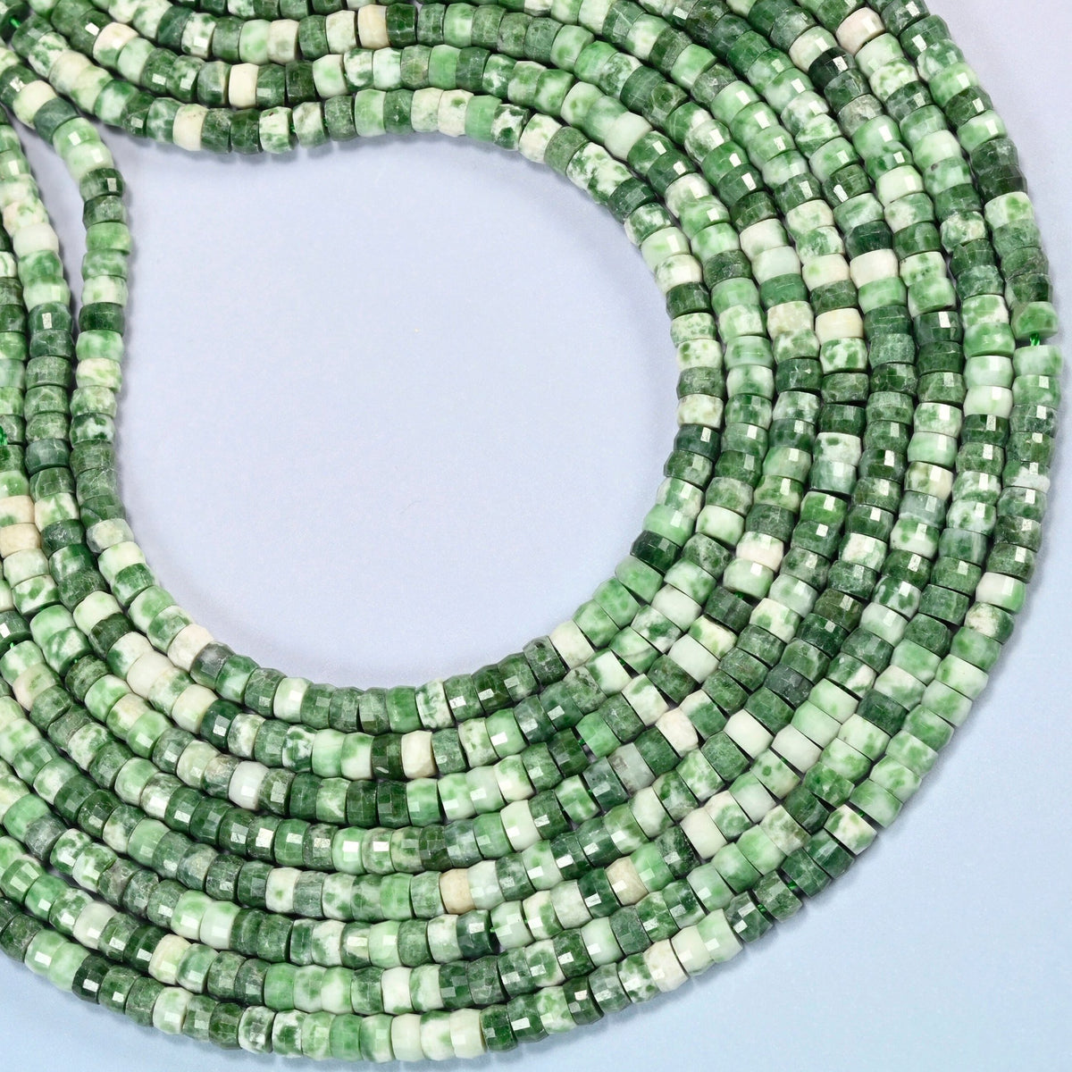 Tree agate faceted heishi disc beads curved into an open loop, green and white beads