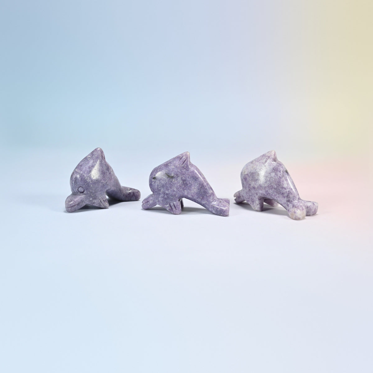 Three lepidolite dolphin crystal carvings, 2 inch, lilac natural stone with purple flecks