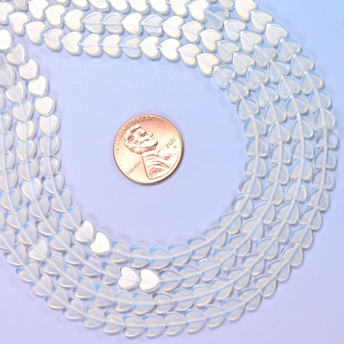 Opalite Flat Heart Beads, small flat hearts in milky white man-made glass with a blue opalescent glow