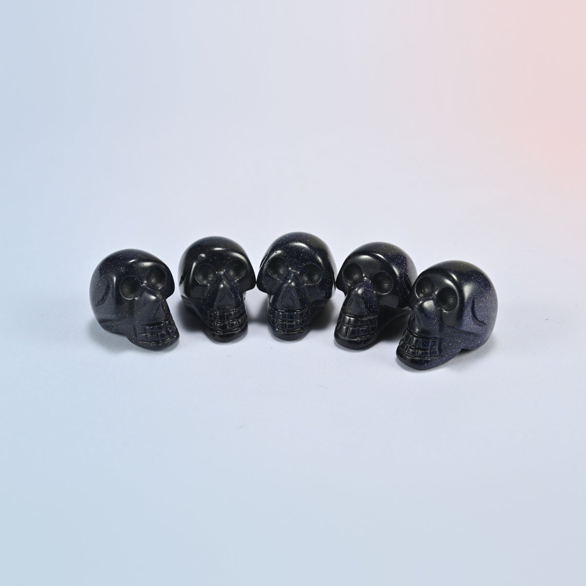 1 inch skull crystal carving in blue sandstone, deep blue man-made glass with sparkle
