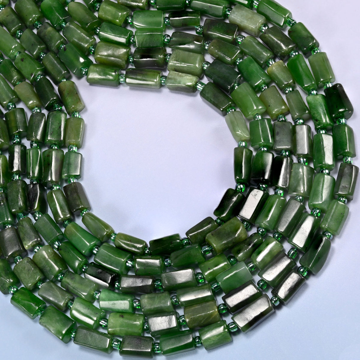 Canadian Green Jade faceted tube beads coiled in a full loop, a 15.5 inch strand holding roughly 30 beads