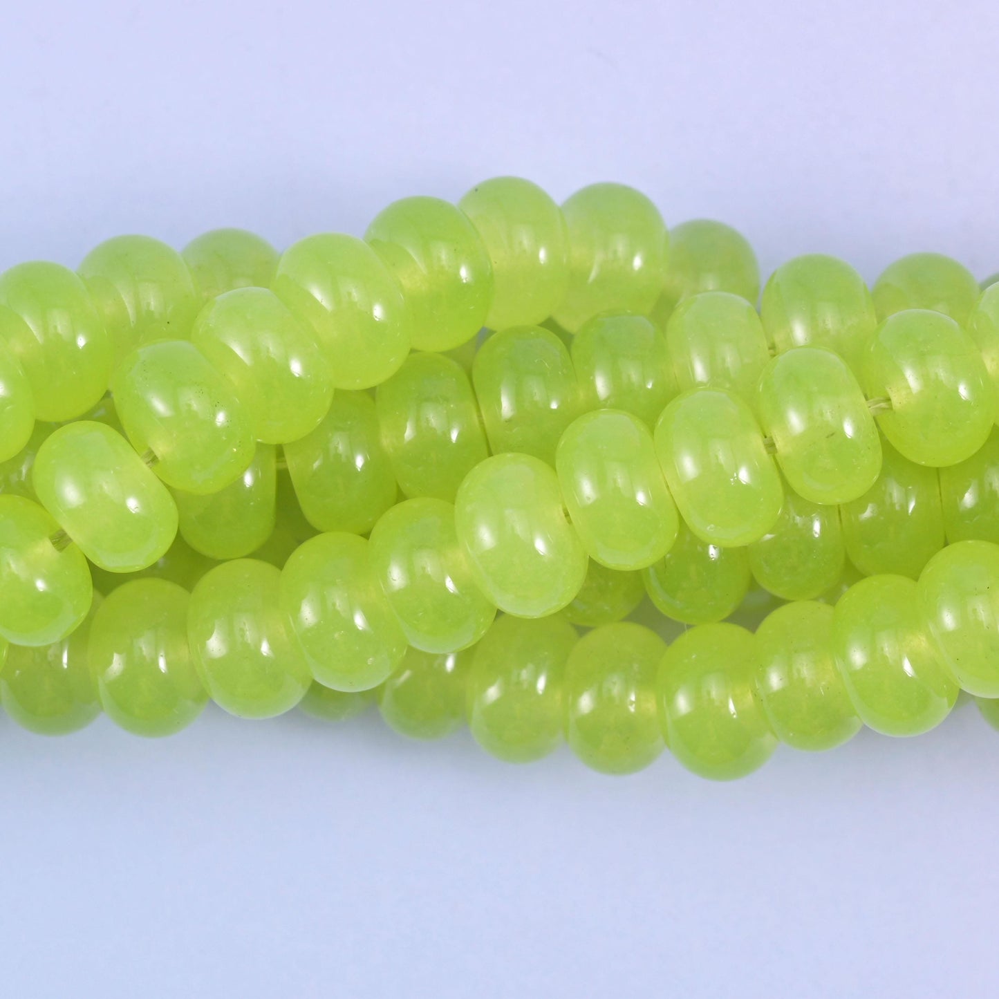 Smooth rondelle cut dyed jade beads with a polished surface