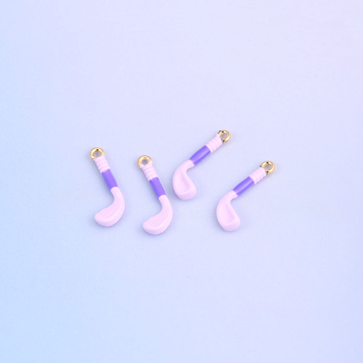 Four light purple golf club charms with purple enamel grips.