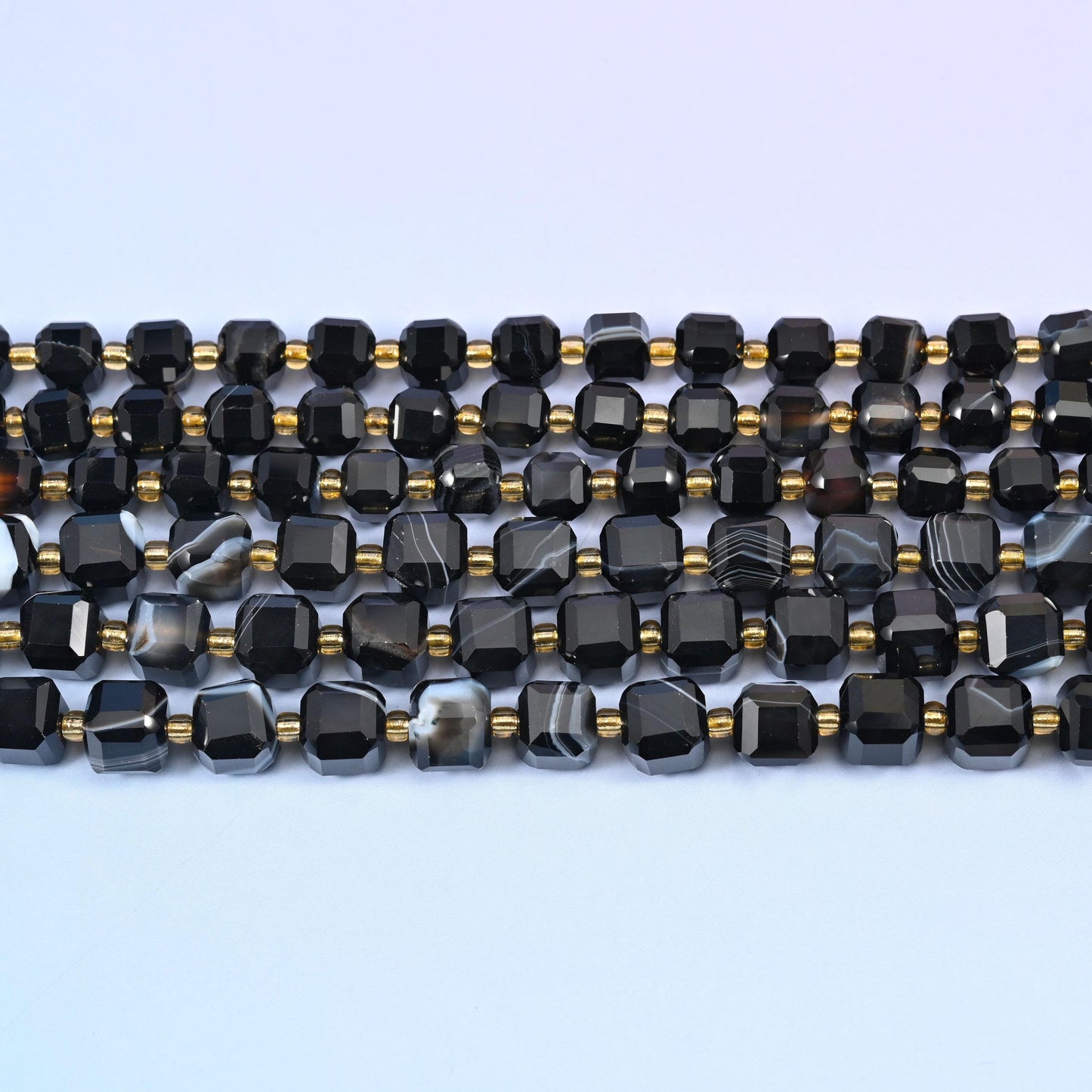 Dyed black strip agate faceted cube beads in deep glossy black with white and grey banding