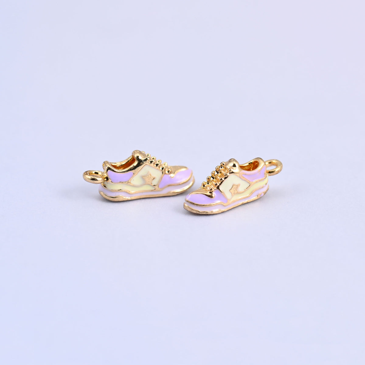 Two light purple sneaker charms angled to show the 4.45mm thick molded shoe.