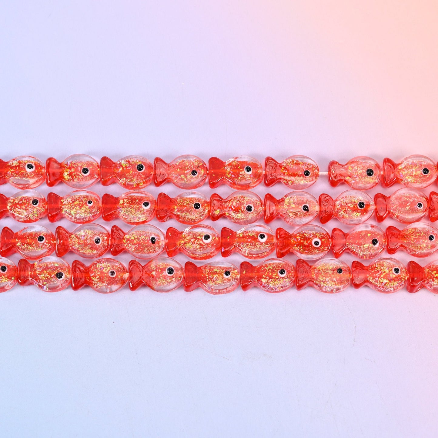 Red Fish Glass Beads with coral red heads and tails, gold glitter flecks