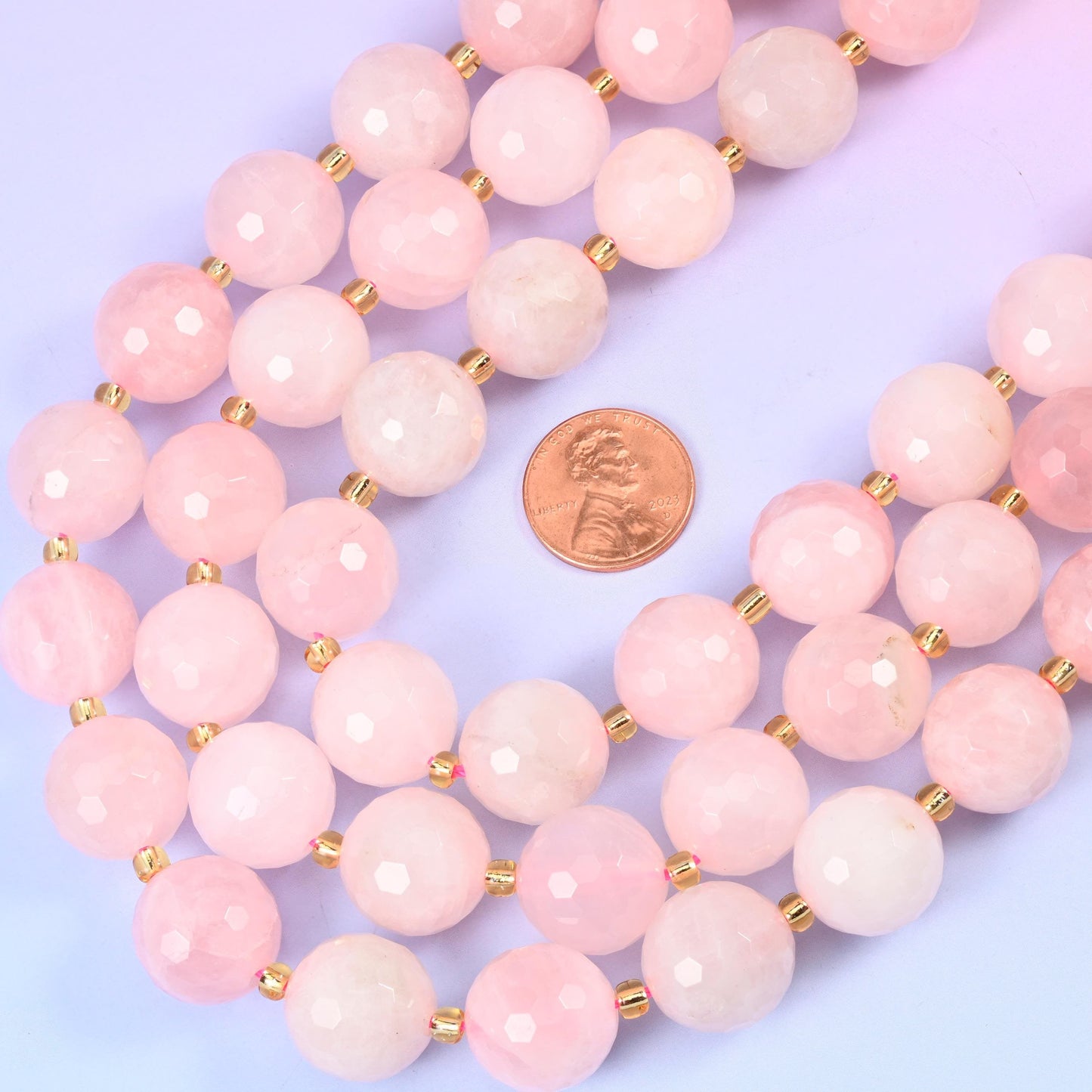 Rose quartz faceted round beads, approximately 21 beads per strand