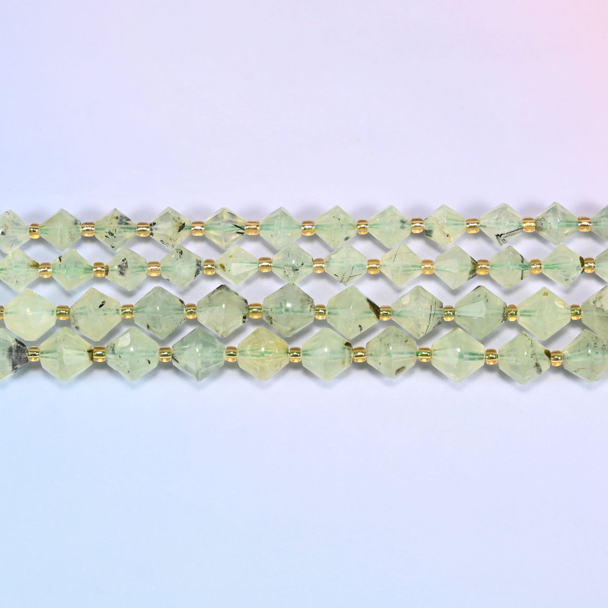 A single straight strand of Green Prehnite faceted bicone beads, 8mm and 10mm, laid flat showing the full 15 inch length.