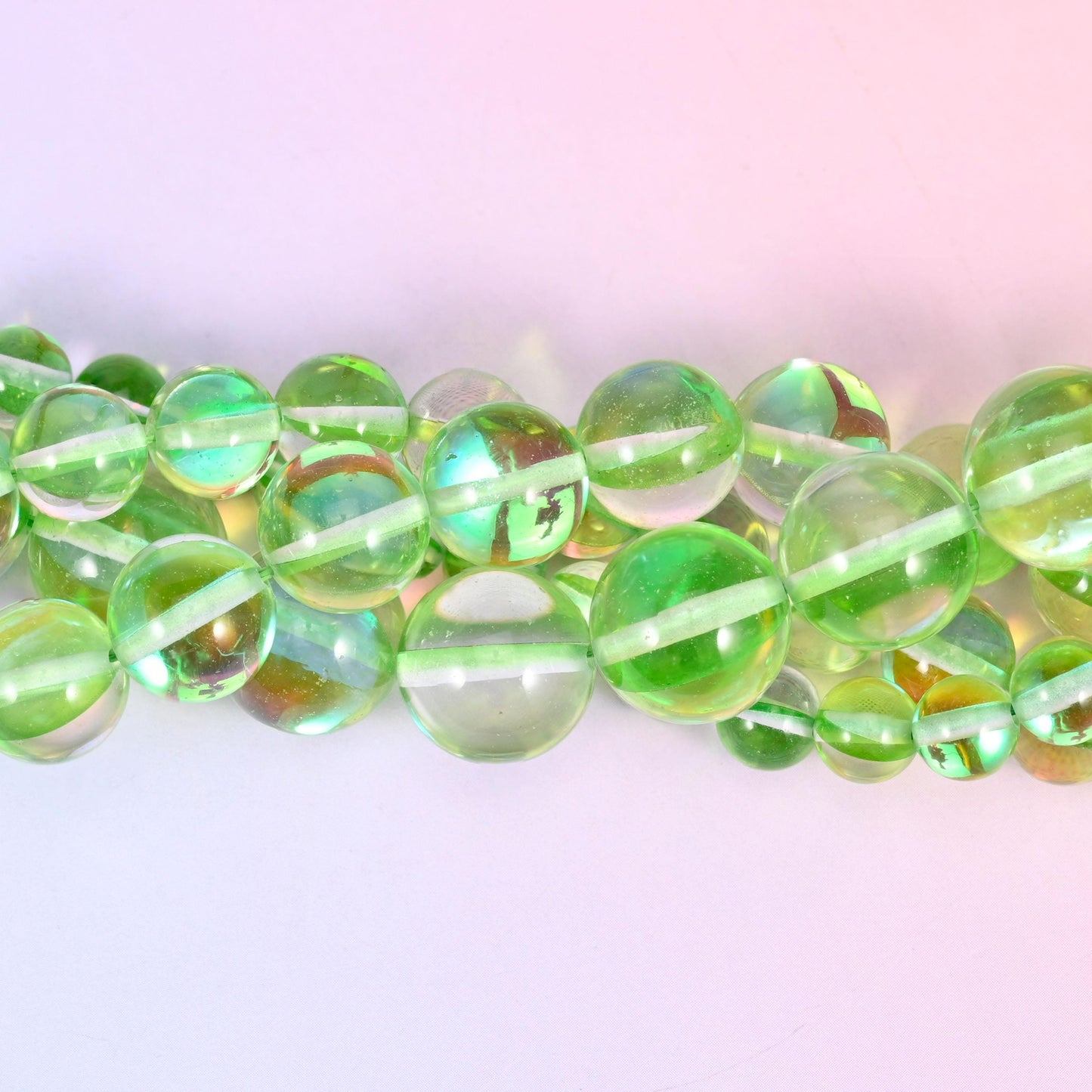 Bright apple-green translucent glass under a strong iridescent coating that throws gold, teal and violet flashes