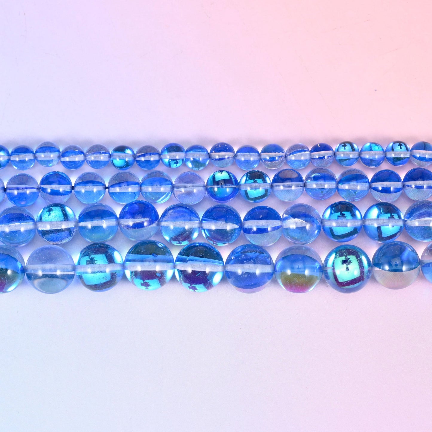 Iridescent Blue Round Glass Beads in translucent cornflower blue with a turquoise, violet and silver aurora coating