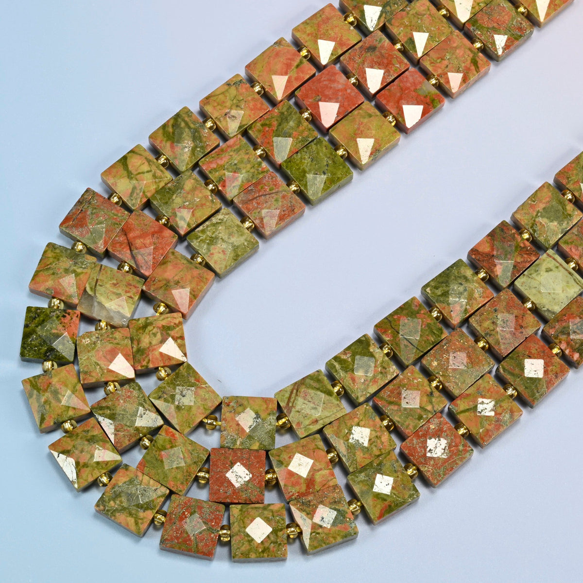 Natural unakite faceted flat square beads in several strands curved into a wide U, olive green stone with salmon pink patches