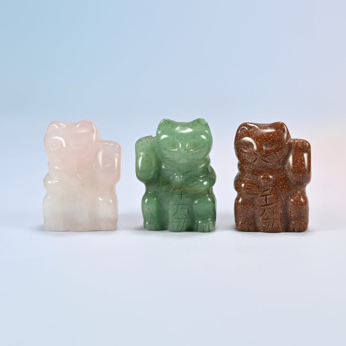 Three 1.5 inch lucky cat crystal carvings in natural rose quartz, natural green aventurine and gold sandstone (man-made glass)