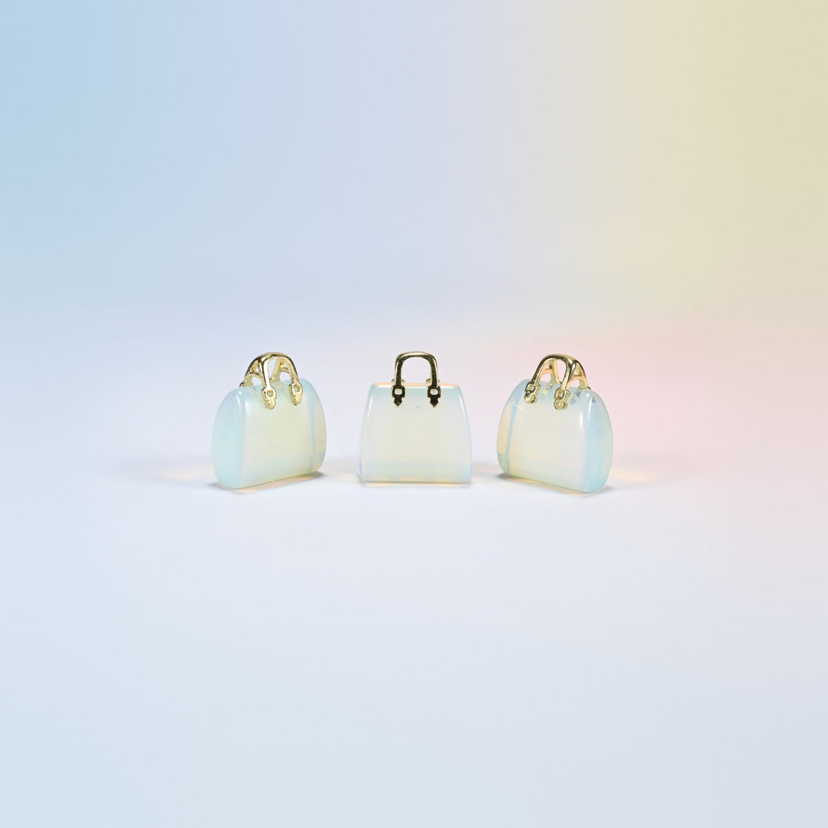 Three opalite purse crystal carvings, 1 inch, glowing milky white man-made glass, gold-tone handle