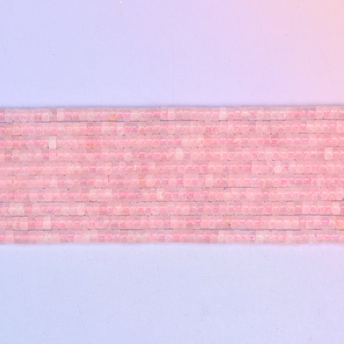 Rose Quartz Smooth Heishi Disc Beads in soft to vivid pink with a translucent glow