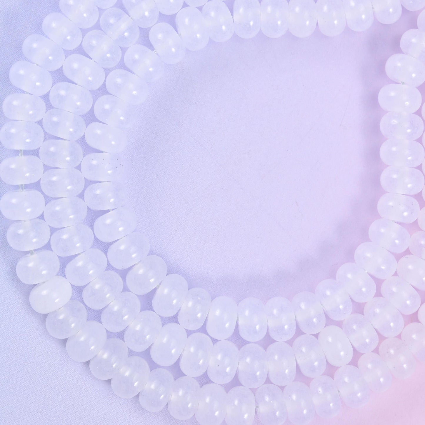 White Dyed Jade smooth rondelle beads in a soft, translucent white, finished with a smooth, polished surface
