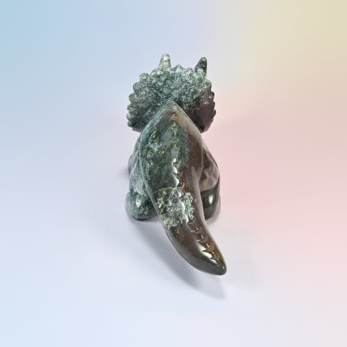 Back view of the Indian agate triceratops carving, carved tail ridges and green and white frill