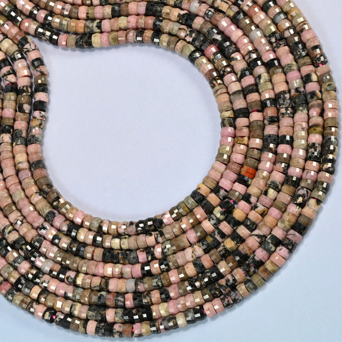Rhodonite faceted heishi disc beads curved into an open loop, pink, gray and black beads