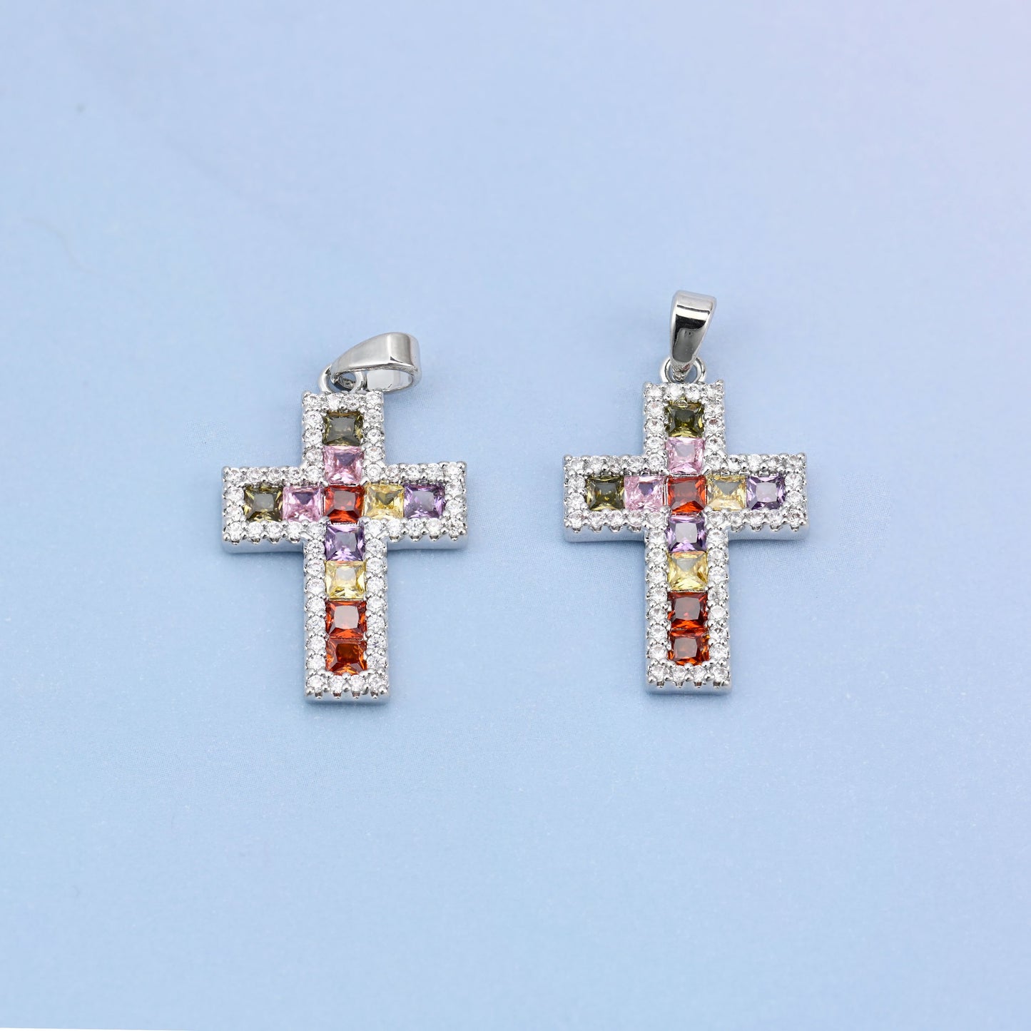 Zirconia cross charms, two white gold plated pendants shown front on with multicolour stones