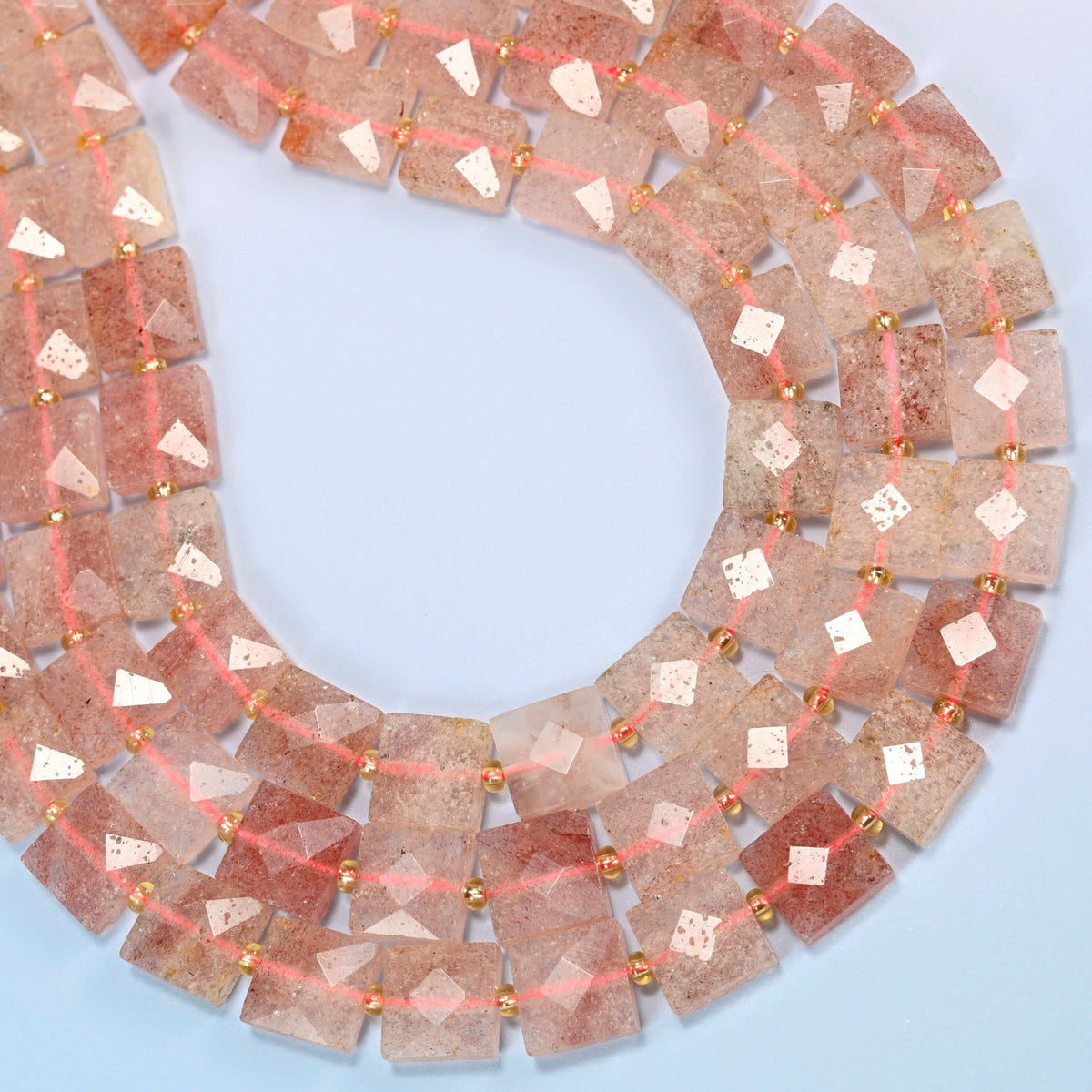Natural strawberry quartz faceted flat square beads curved into an open loop, soft pink and translucent beads with red flecks