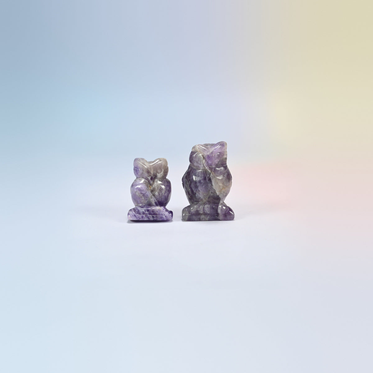 Owl crystal carving in amethyst, purple and white natural stone