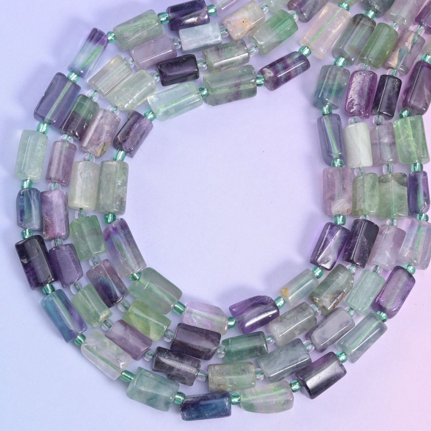 Multi-Color Fluorite faceted tube beads, approximately 29 beads per strand.