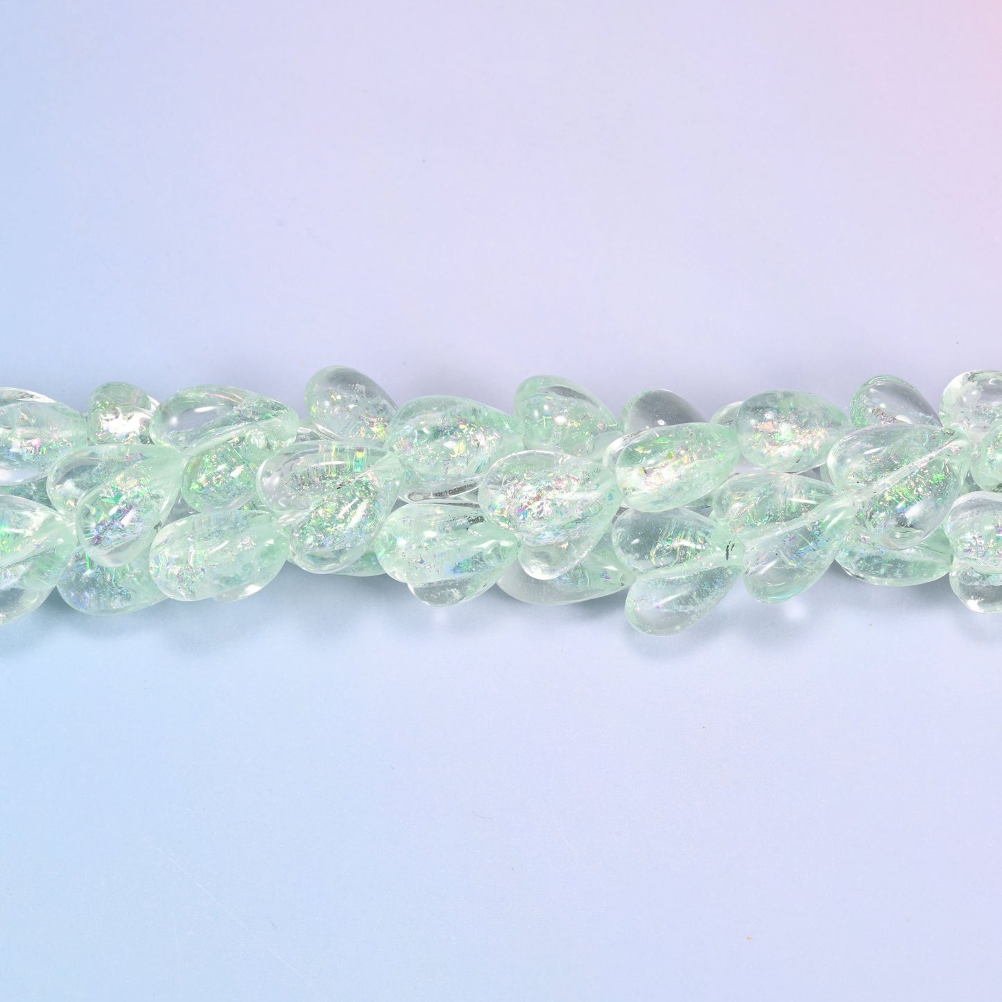 Clear pale mint glass hearts carrying a fine iridescent shimmer that shifts towards silver and pale gold