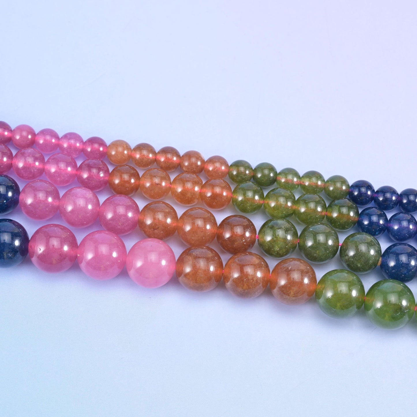 Dyed jade round beads in bright rose pink, mossy olive green, terracotta copper and deep navy blue