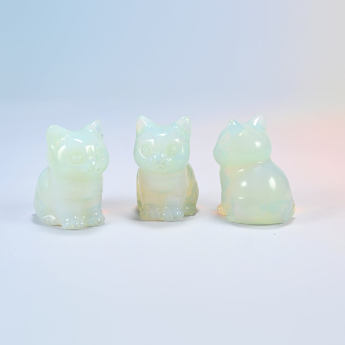 Three opalite sitting cat carvings, 1.5 inch, glowing man-made glass