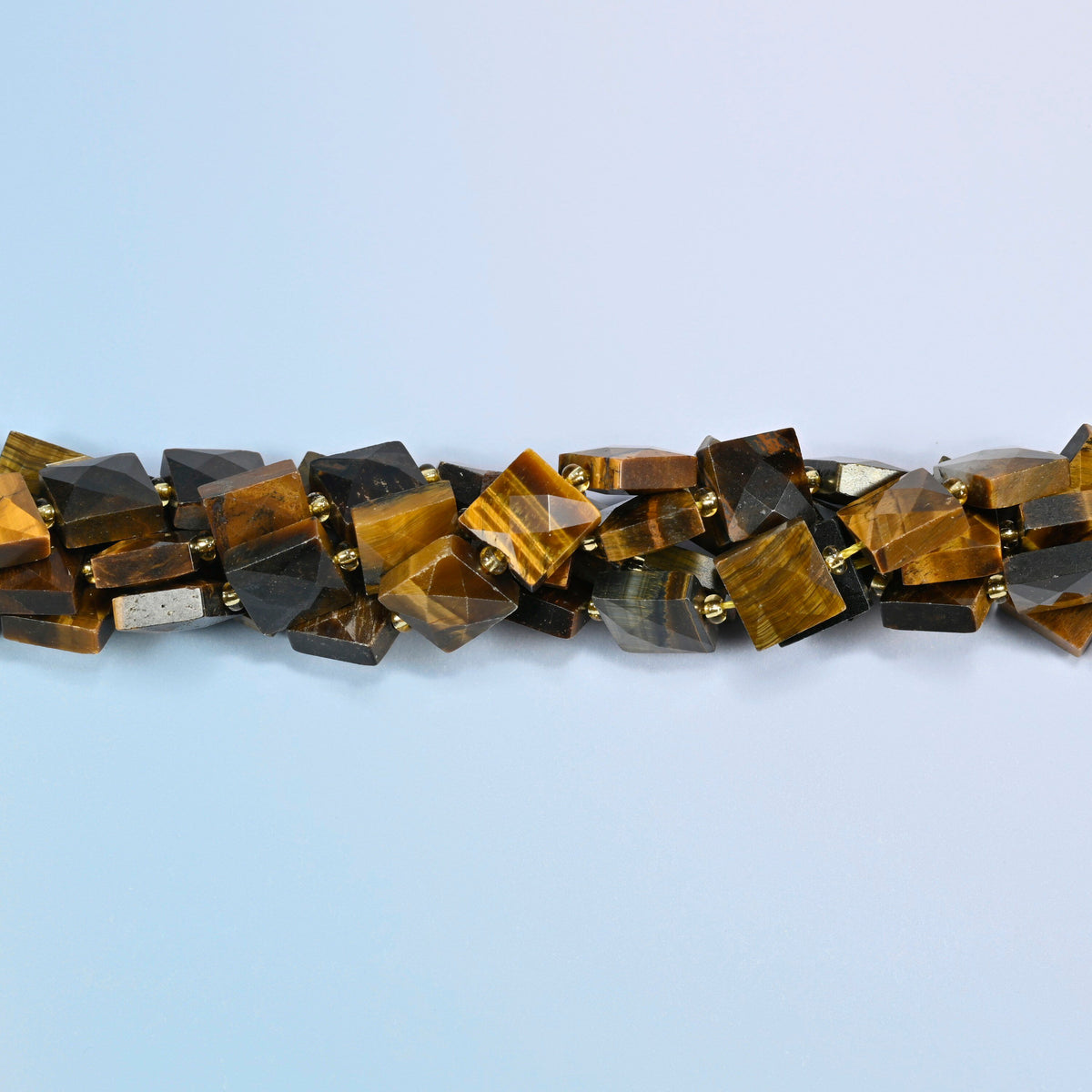 Strands of natural tiger eye faceted flat square beads twisted together in a horizontal row