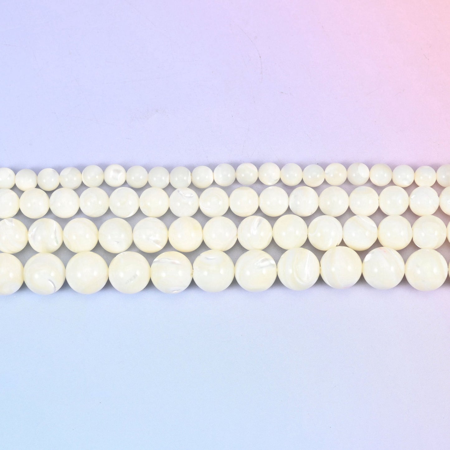 White trochus shell round beads in creamy ivory with faint pearly growth lines