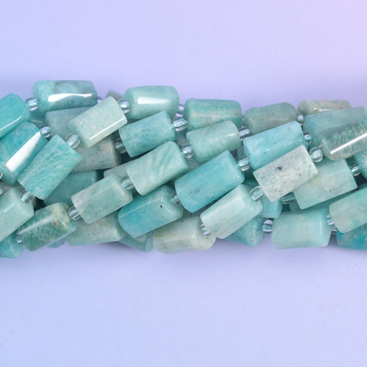 Close-up detail of amazonite tubes, with milky white streaking and soft green banding through the stone