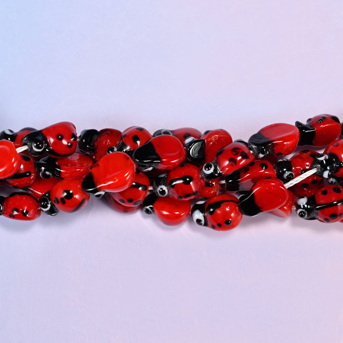 Red ladybug glass beads for garden-theme stretch bracelets and charm necklaces.