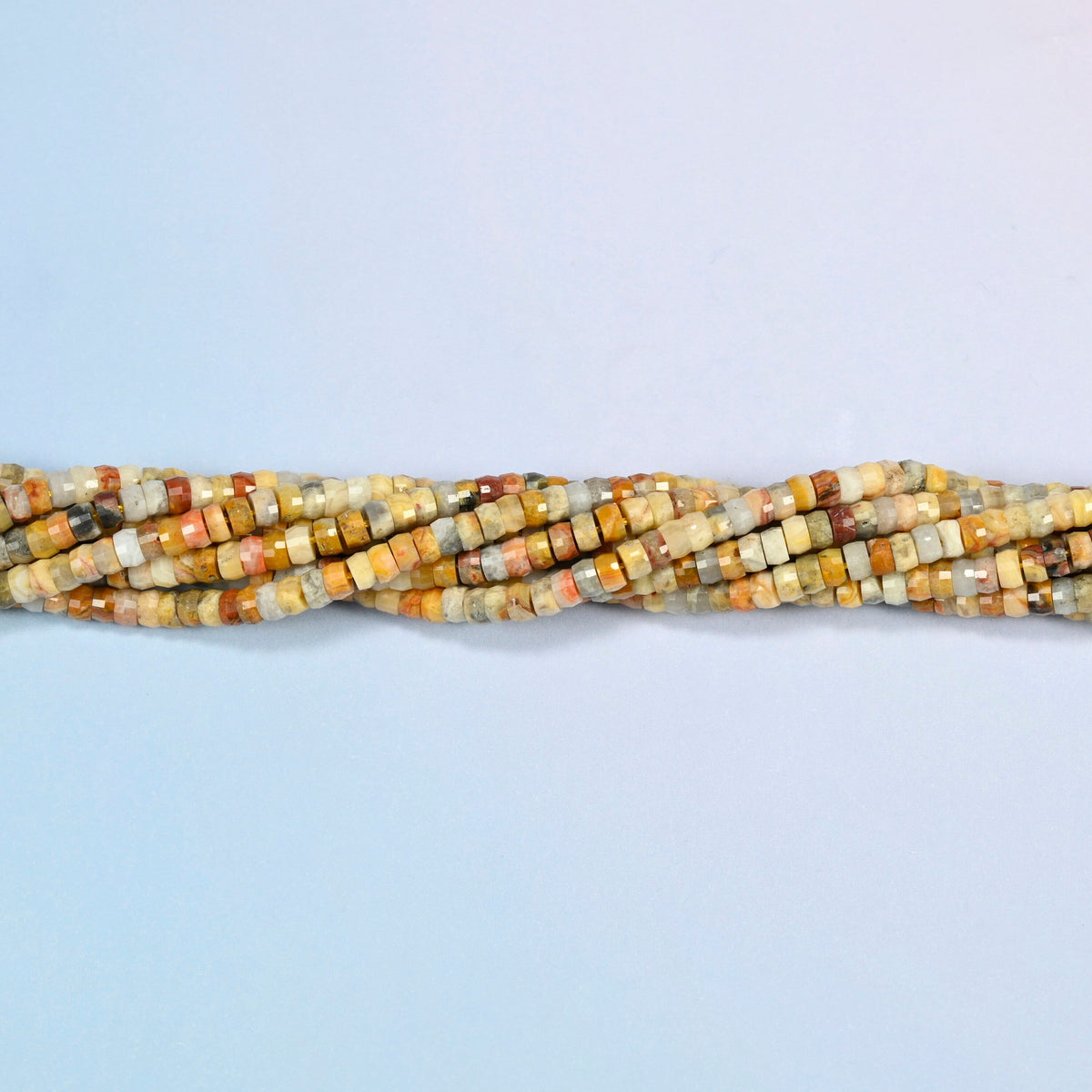 Strands of crazy agate faceted heishi disc beads twisted together in a horizontal row