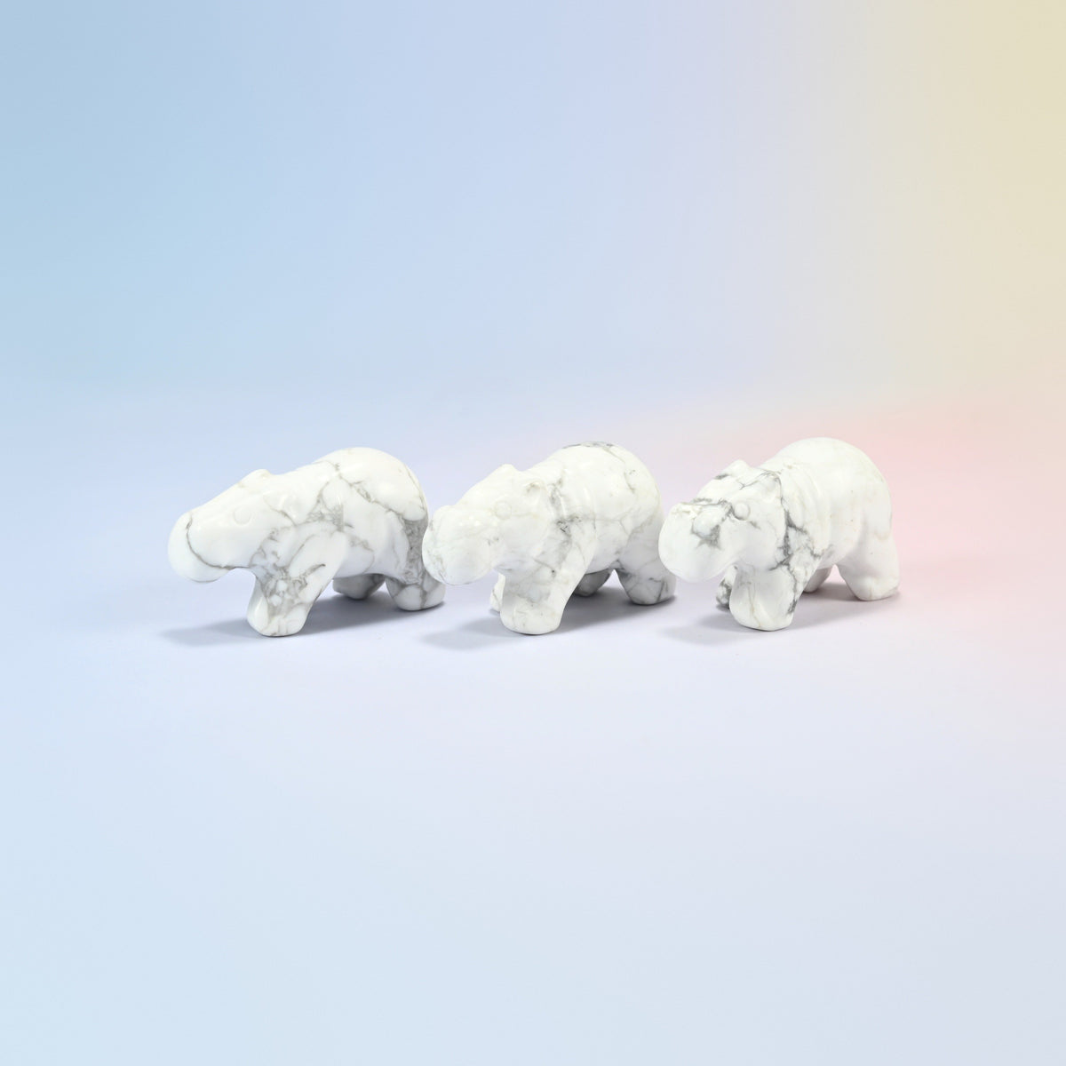 Three natural white howlite hippo crystal carvings, 2 inch, white with gray veining