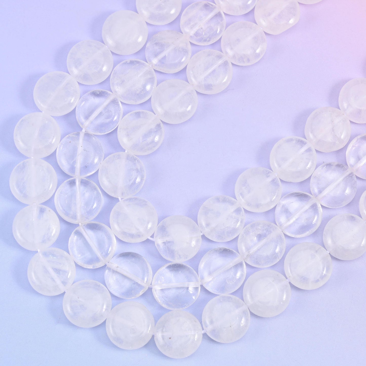 Close curve of the strand showing snowy white veils trapped inside the translucent quartz coins