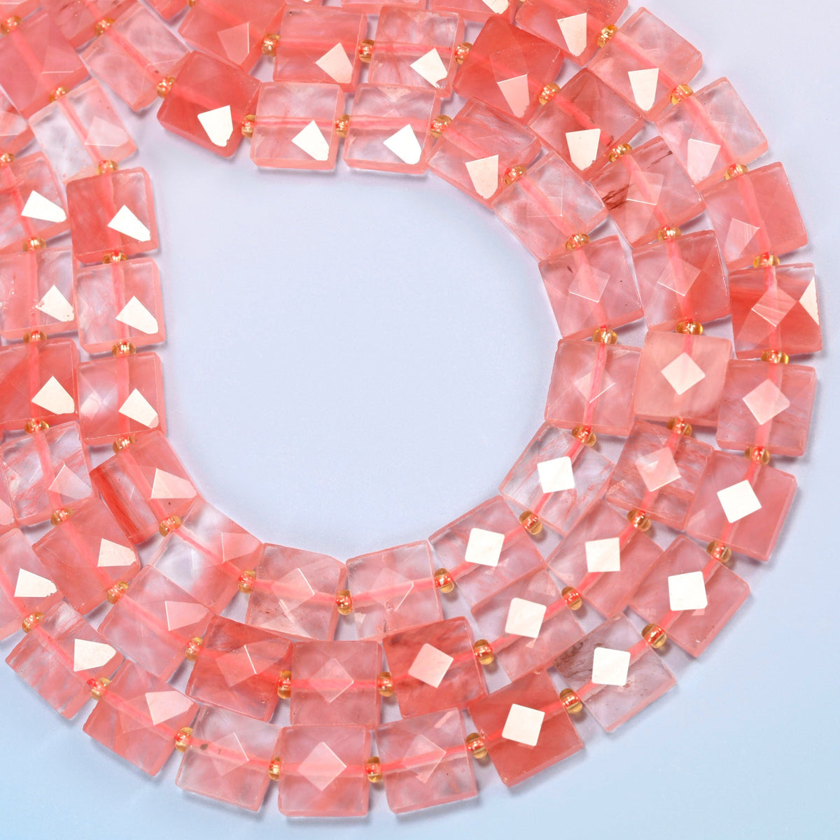 Melon quartz faceted flat square beads curved into an open loop, translucent pink beads with coral pink streaks