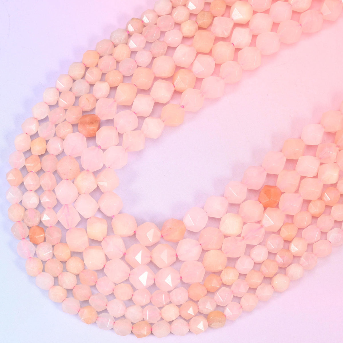 Pink Aventurine diamond star cut beads, strands crossing in a V, natural stone with the shade of pink shifting bead to bead