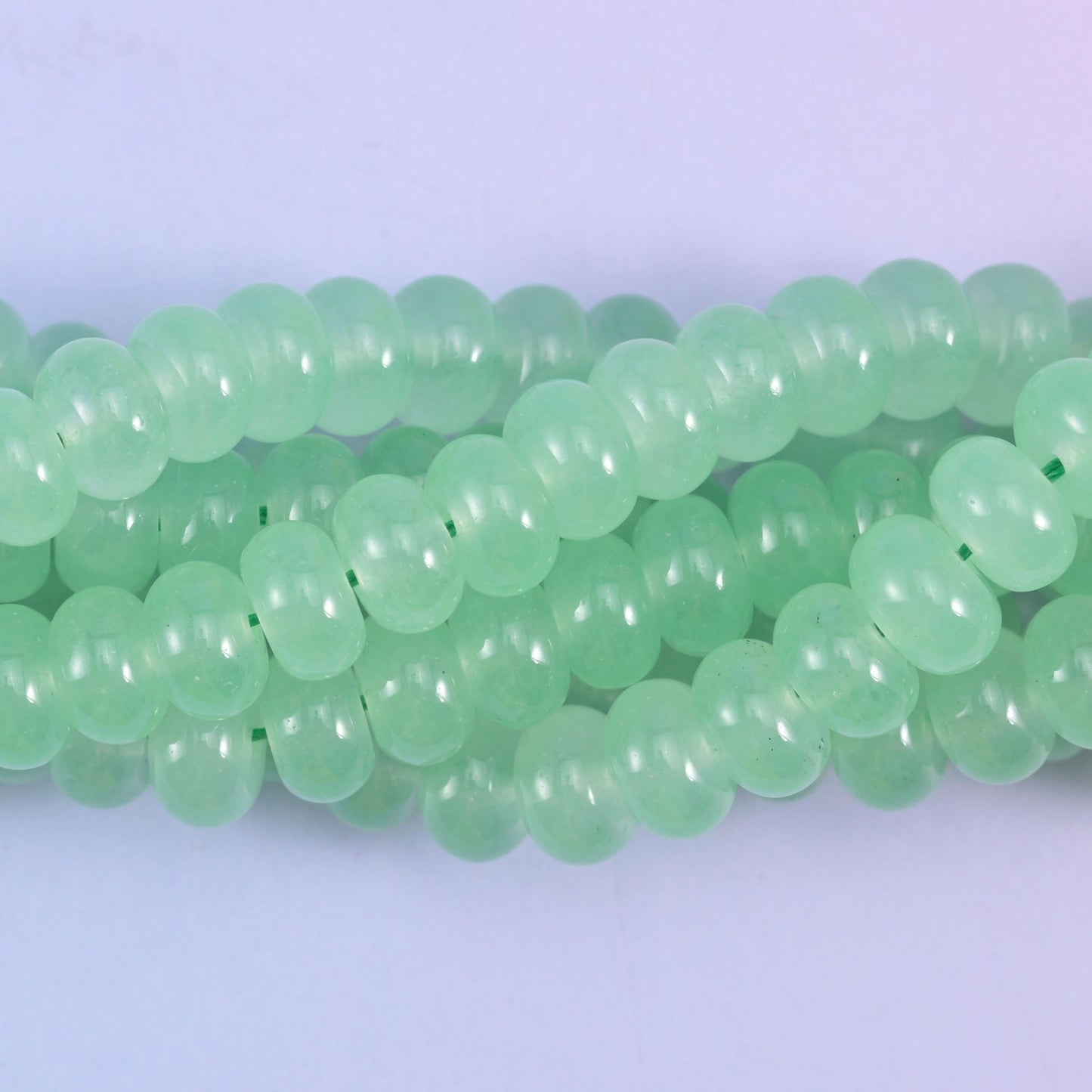 Smooth rondelle cut dyed jade beads with an even glossy polish