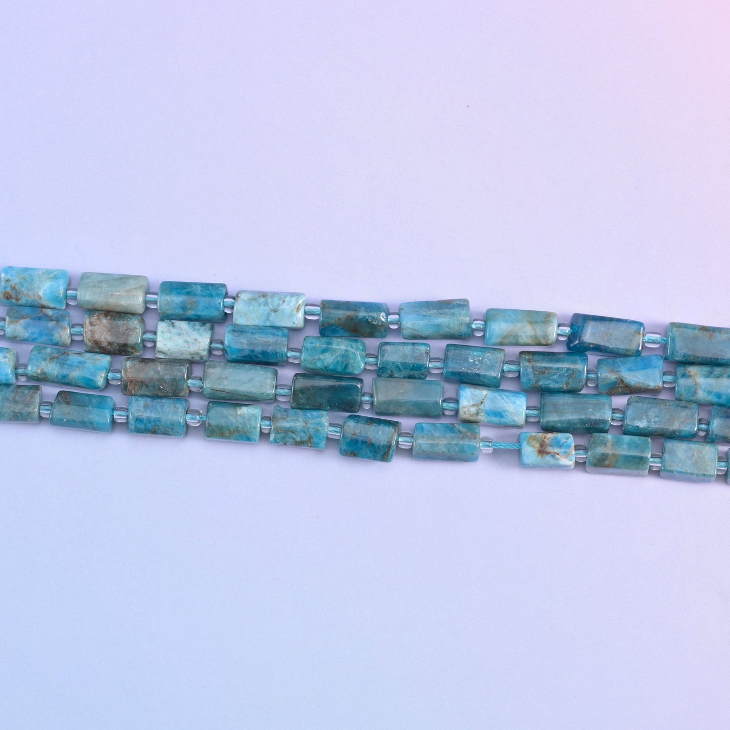 Blue apatite beads in natural color variation
