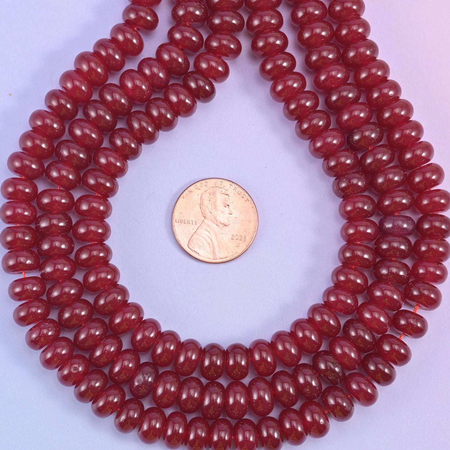 Ruby Red Dyed Jade smooth rondelle beads in a deep, glossy wine-red, finished with a smooth, polished surface