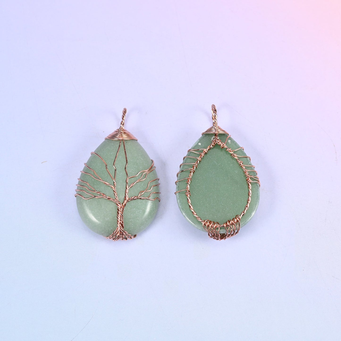 Teardrop Crystal Pendant with Copper Wired Tree in green aventurine, front and back together against a soft lilac gradient background.