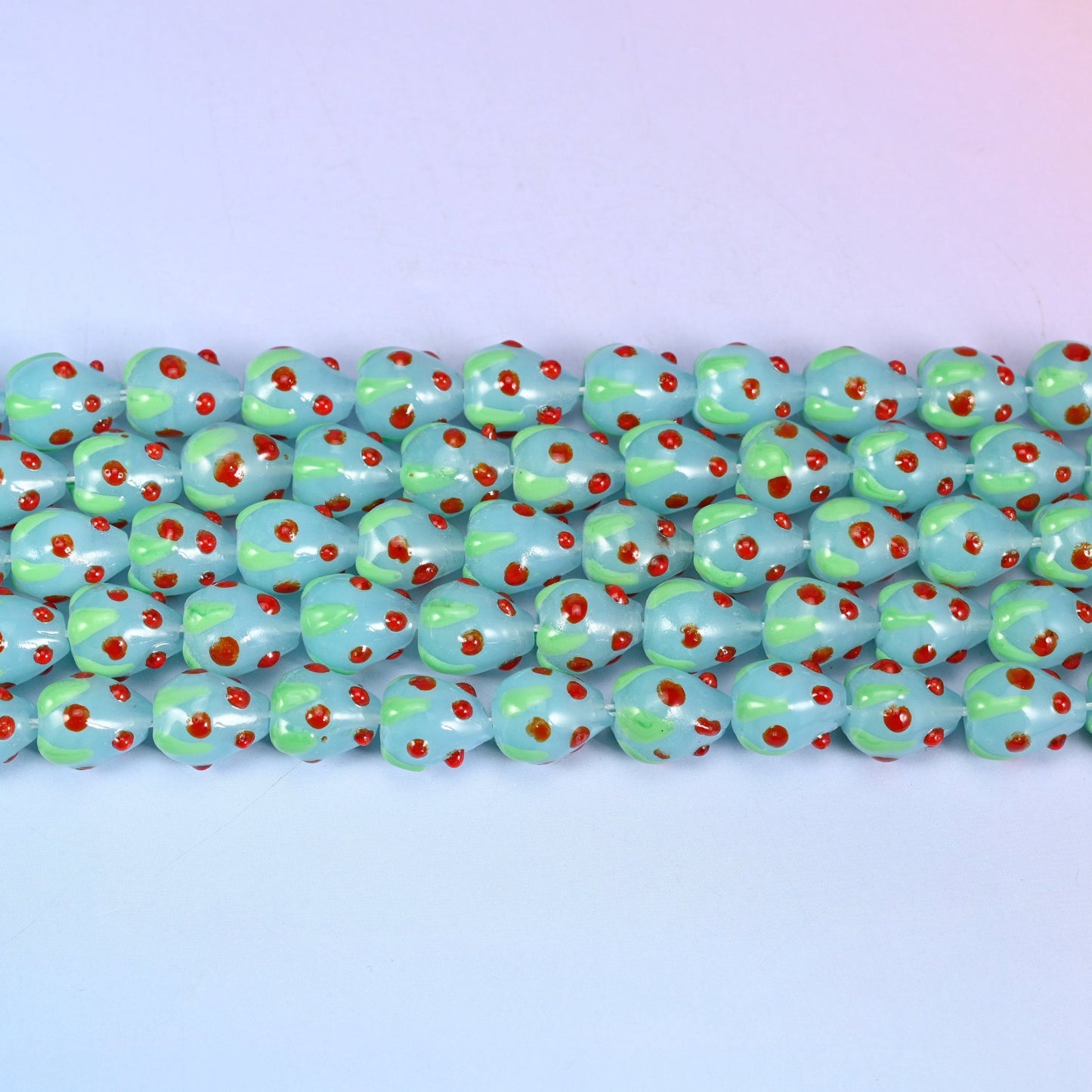 Light Blue Red Dots Strawberry Glass Beads in soft powder-blue with a pale green leaf panel