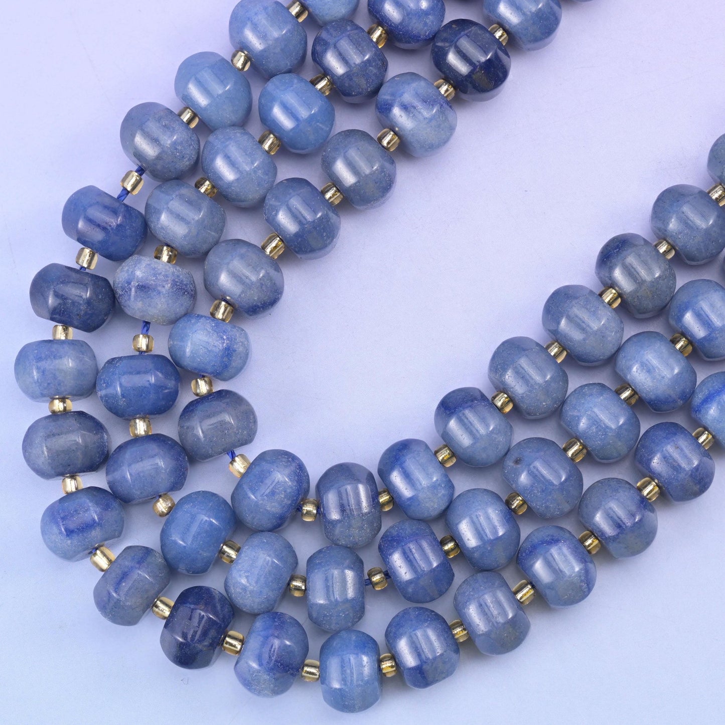 Strands curving downward in a gentle sweep, tone stepping from powder blue to deeper slate