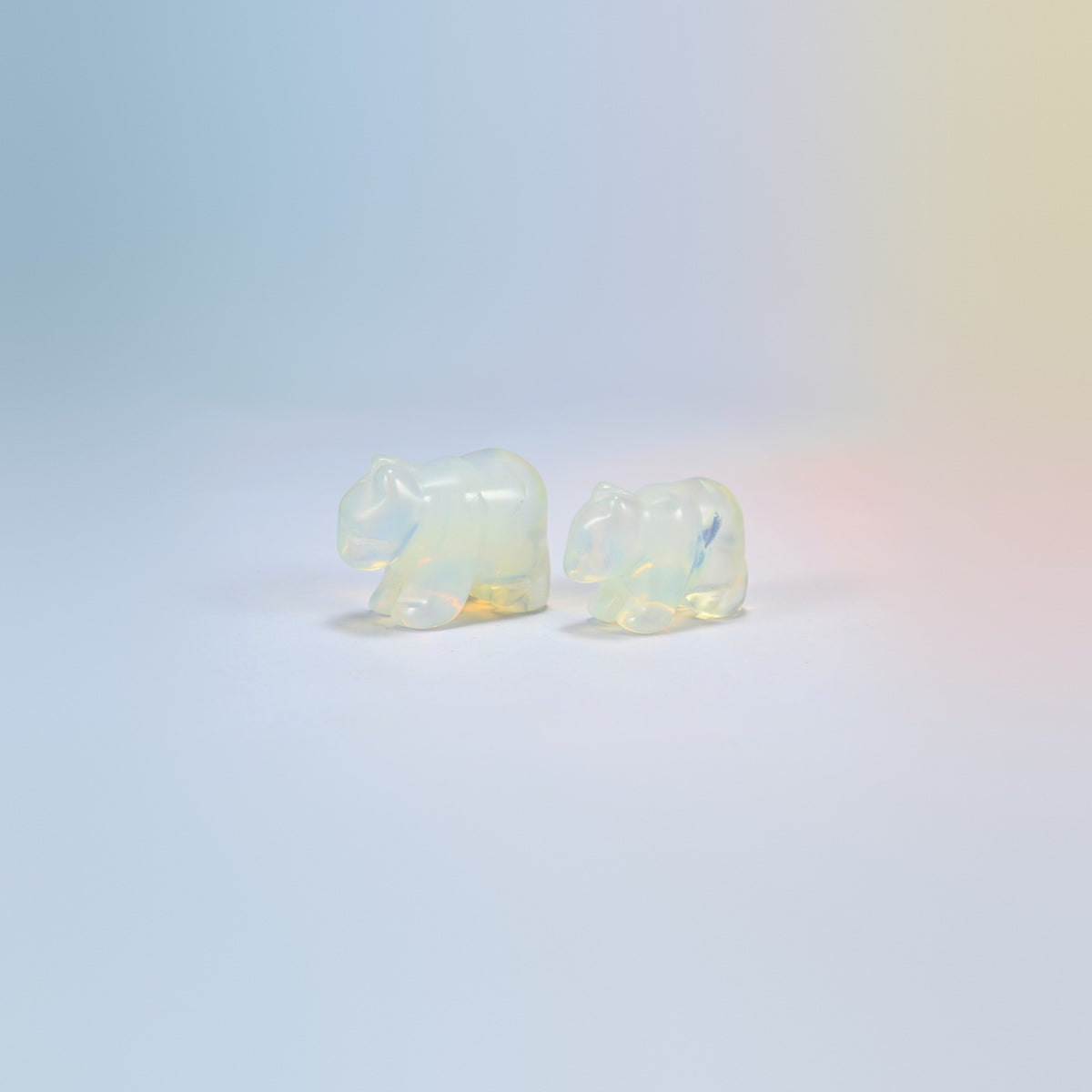 Two 1.5 inch opalite bear crystal carvings, glowing milky white man-made glass