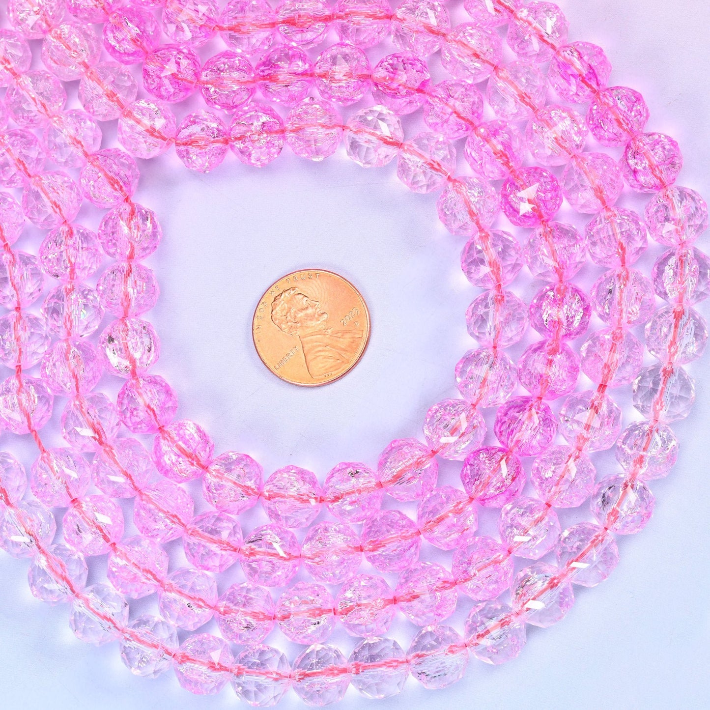 Transparent pink faceted round glass beads, approximately 42 beads per strand